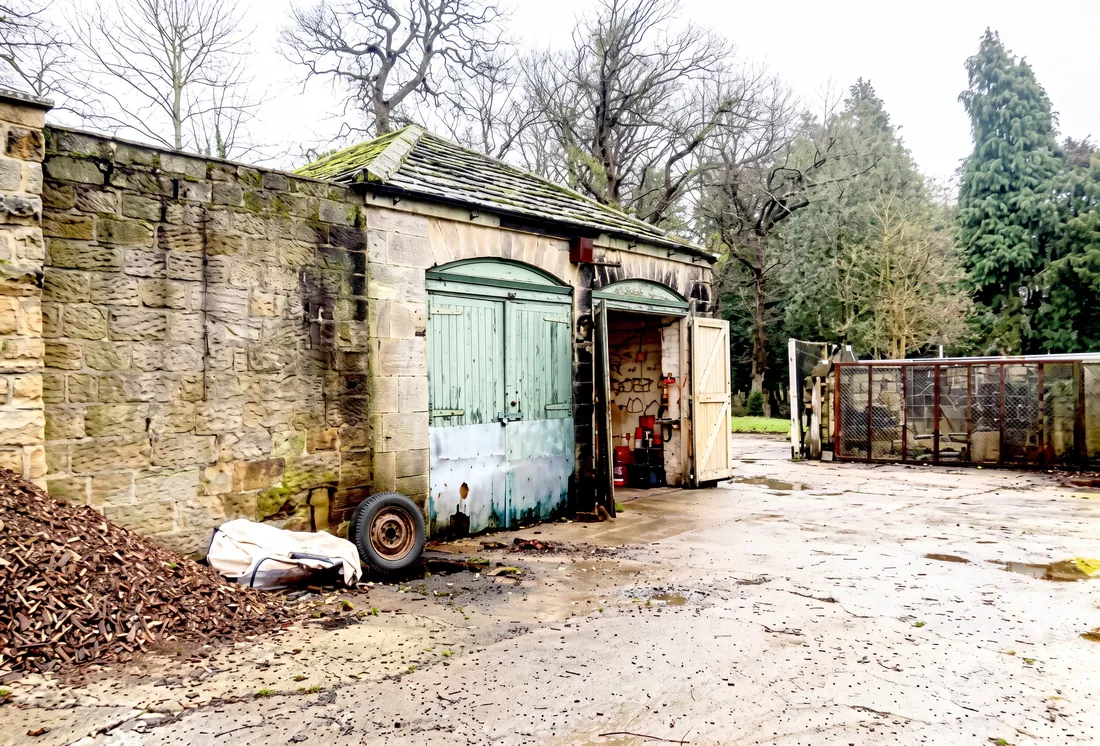 Exterior of the stables and coach house with green arched doors